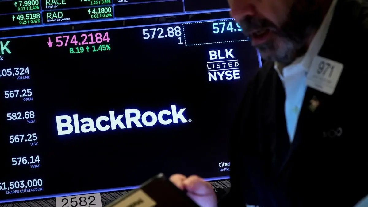 A trader works as a screen displays the trading information for BlackRock on the floor of the New York Stock Exchange (NYSE) in New York City, U.S., October 14, 2022. REUTERS/Brendan McDermid Purchase Licensing Rights, opens new tab